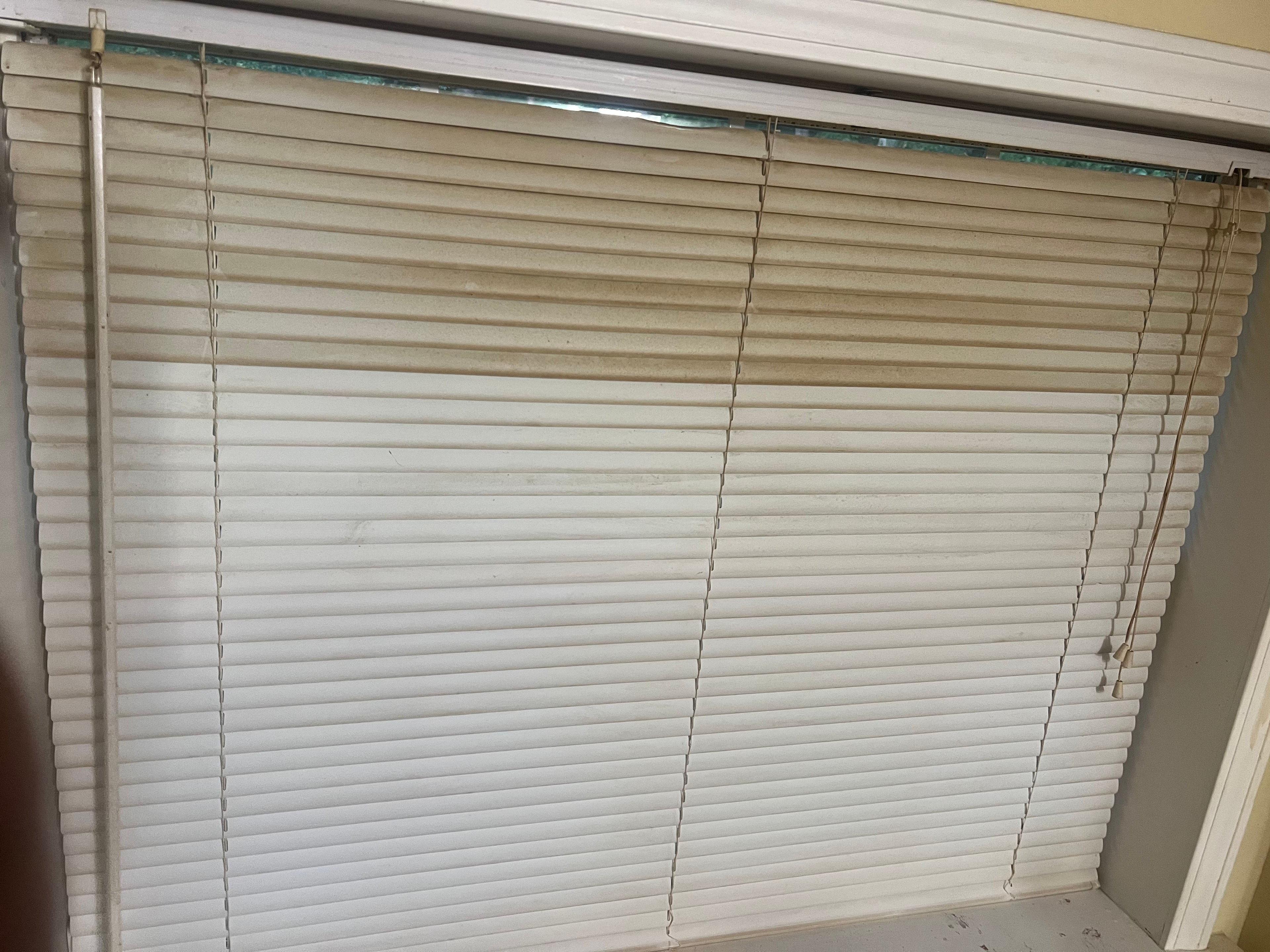 Dusty, grimy horizontal blinds before ultrasonic cleaning